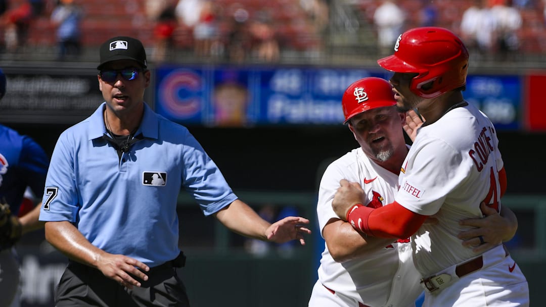 Cardinals first baseman Willson Contreras held back by first base coach Stubby Clapp