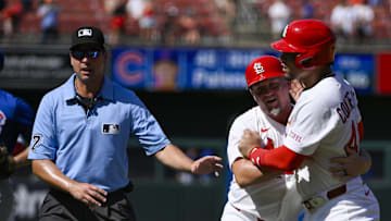 Cardinals first baseman Willson Contreras held back by first base coach Stubby Clapp