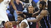 Cavaliers guard Donovan Mitchell drives to the basket beside Magic center Wendell Carter Jr. last season.