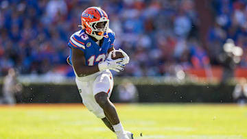 Nov 23, 2024; Gainesville, Florida, USA; Florida Gators running back Jadan Baugh (13) rushes with the ball against the Mississippi Rebels during the first half at Ben Hill Griffin Stadium. Mandatory Credit: Matt Pendleton-Imagn Images