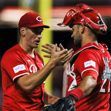 Sep 4, 2024; Cincinnati, Ohio, USA; Cincinnati Reds relief pitcher Brent Suter (31) shakes hands with catcher Luke Maile (22) after the victory over the Houston Astros at Great American Ball Park. Mandatory Credit: Katie Stratman-Imagn Images