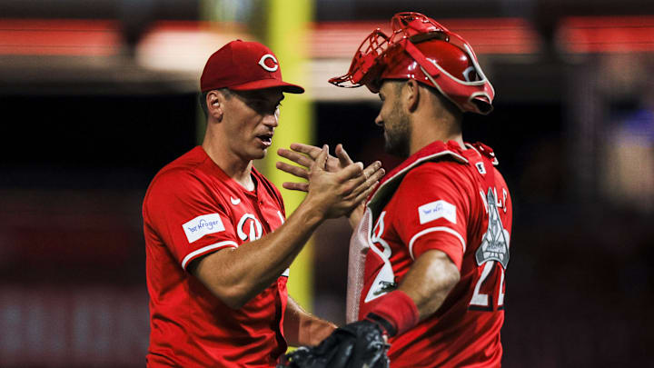 Sep 4, 2024; Cincinnati, Ohio, USA; Cincinnati Reds relief pitcher Brent Suter (31) shakes hands with catcher Luke Maile (22) after the victory over the Houston Astros at Great American Ball Park. Mandatory Credit: Katie Stratman-Imagn Images