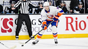 Jan 11, 2025; Salt Lake City, Utah, USA; New York Islanders defenseman Noah Dobson (8) passes the puck against the Utah Hockey Club during first period at the Delta Center. Mandatory Credit: Christopher Creveling-Imagn Images