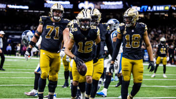 Dec 10, 2023; New Orleans, Louisiana, USA; New Orleans Saints wide receiver Chris Olave (12) reacts to making a touchdown against Carolina Panthers safety Vonn Bell (24) during the second half at the Caesars Superdome. Mandatory Credit: Stephen Lew-USA TODAY Sports