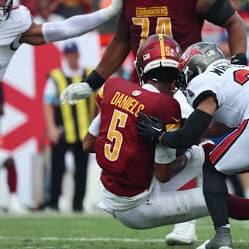 Sep 8, 2024; Tampa, Florida, USA;  Tampa Bay Buccaneers safety Antoine Winfield Jr. (31) hits Washington Commanders quarterback Jayden Daniels (5) in the helment during the first half at Raymond James Stadium. Mandatory Credit: Kim Klement Neitzel-Imagn Images