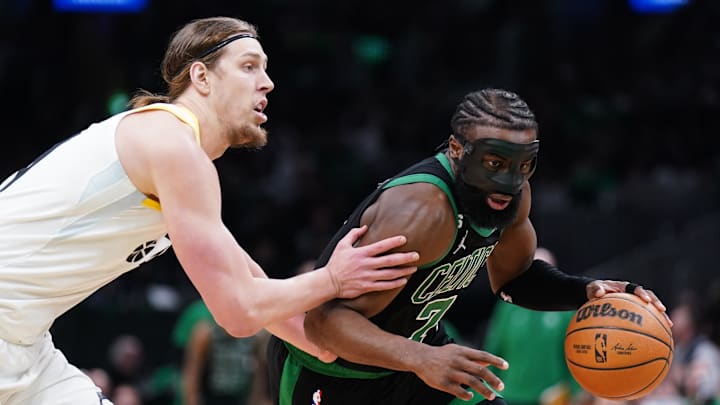 Mar 31, 2023; Boston, Massachusetts, USA; Boston Celtics guard Jaylen Brown (7) drives the ball against Utah Jazz forward Kelly Olynyk (41) in the second quarter at TD Garden. Mandatory Credit: David Butler II-Imagn Images