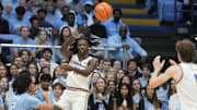 Nov 17, 2023; Chapel Hill, North Carolina, USA; UC Riverside Highlanders guard Nate Pickens (11) passes the ball to center Benjamin Griscti (1) as North Carolina Tar Heels guard Elliott Cadeau (2) defends in the first half at Dean E. Smith Center. Mandatory Credit: Bob Donnan-Imagn Images