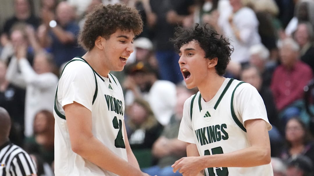 Sunnyslope Vikings teammates Darius Wabbington (21) and Rider Portela (15) celebrate a defensive stop in the final seconds of their 58-53 win over the Millennium Tigers during their Open Division boys basketball state semifinals game at Chaparral High School in Phoenix on March 5, 2025.