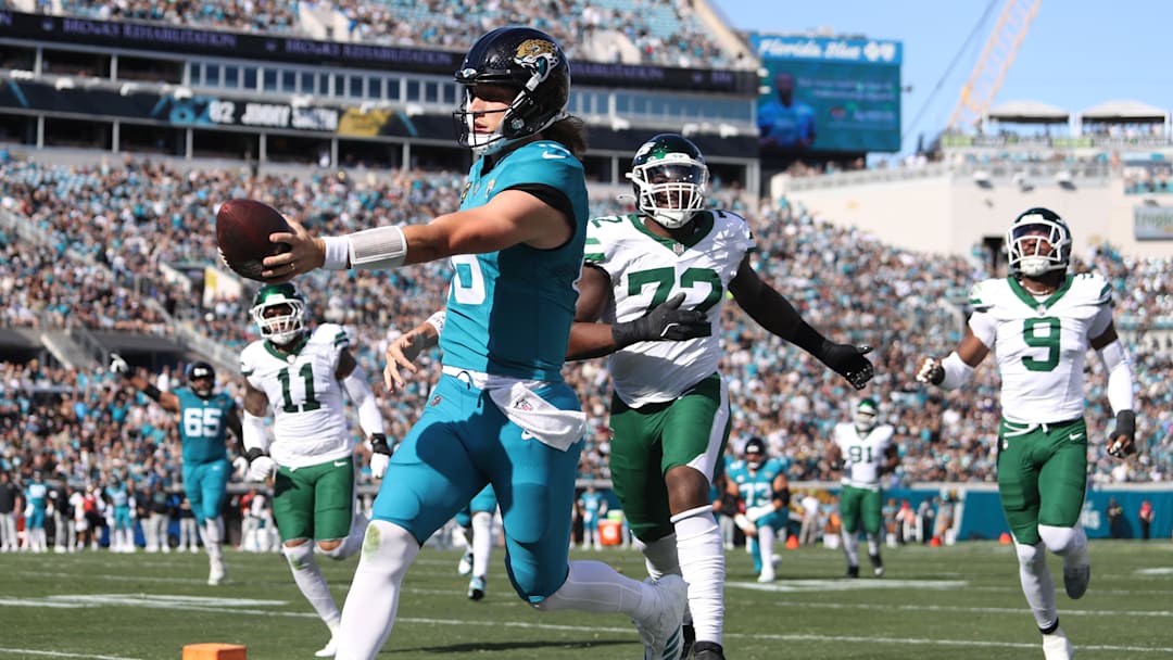 Dec 14, 2025; Jacksonville, Florida, USA; Jacksonville Jaguars quarterback Trevor Lawrence (16) scores a touchdown during the first quarter against the New York Jets at EverBank Stadium. Mandatory Credit: Morgan Tencza-Imagn Images
