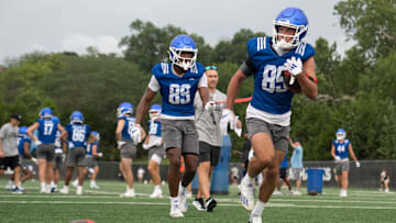 Kansas freshman wide receivers Tate Nagy (85) works with freshman Jackson Cook (89) during practice at the outdoor practice fields in Lawrence on July 24, 2025.