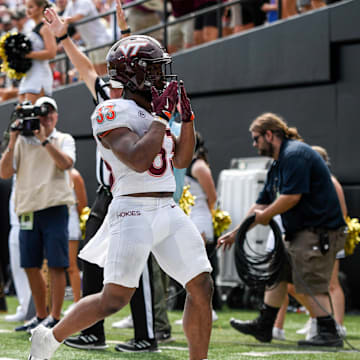 Aug 31, 2024; Nashville, Tennessee, USA;  Virginia Tech Hokies running back Bhayshul Tuten (33) celebrates his touchdown against the Vanderbilt Commodores during the second half at FirstBank Stadium. Mandatory Credit: Steve Roberts-Imagn Images