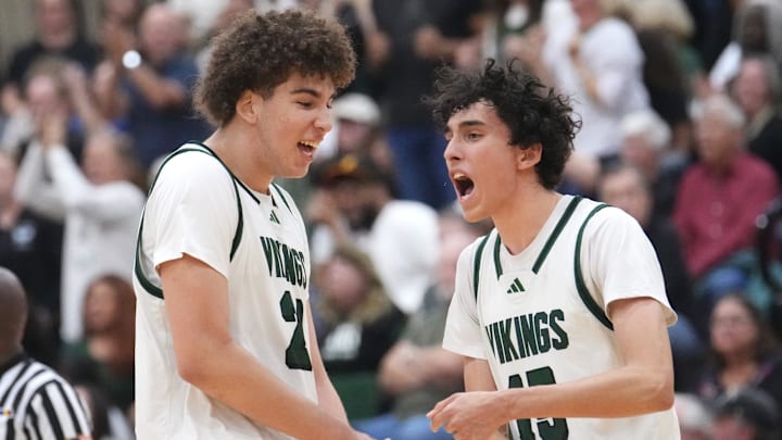 Sunnyslope Vikings teammates Darius Wabbington (21) and Rider Portela (15) celebrate a defensive stop in the final seconds of their 58-53 win over the Millennium Tigers during their Open Division boys basketball state semifinals game at Chaparral High School in Phoenix on March 5, 2025.