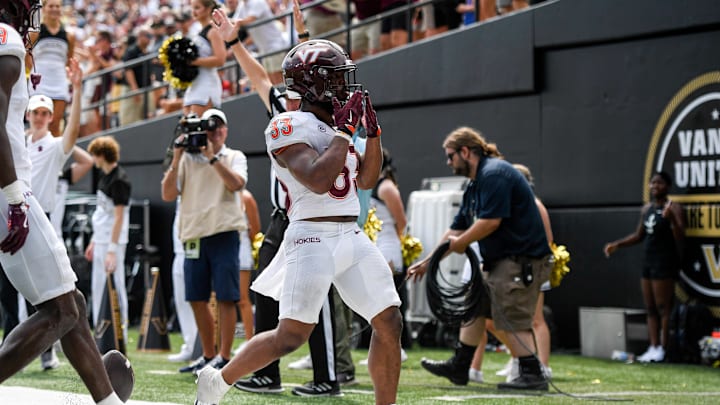 Aug 31, 2024; Nashville, Tennessee, USA;  Virginia Tech Hokies running back Bhayshul Tuten (33) celebrates his touchdown against the Vanderbilt Commodores during the second half at FirstBank Stadium. Mandatory Credit: Steve Roberts-Imagn Images