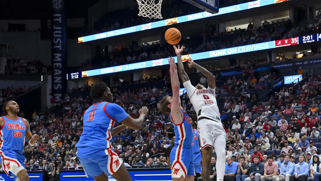Mar 13, 2026; Nashville, TN, USA;  Alabama Crimson Tide guard Labaron Philon (0) shoots over Mississippi Rebels guard Travis Perry (11) during the first half at Bridgestone Arena. Mandatory Credit: Steve Roberts-Imagn Images