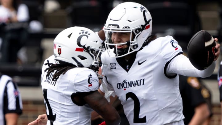 Cincinnati Bearcats quarterback Brendan Sorsby (2) reacts with Cincinnati Bearcats wide receiver Tyrin Smith (4) after scoring a touchdown in the first quarter of the College Football game between the Cincinnati Bearcats and the Towson Tigers at Nippert Stadium in Cincinnati on Saturday, Aug. 31, 2024.