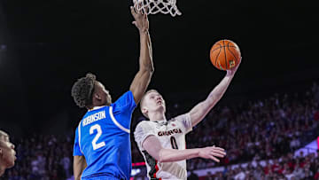 Jan 7, 2025; Athens, Georgia, USA; Georgia Bulldogs guard Blue Cain (0) shoots against Kentucky Wildcats guard Jaxson Robinson (2) during the first half at Stegeman Coliseum. Mandatory Credit: Dale Zanine-Imagn Images