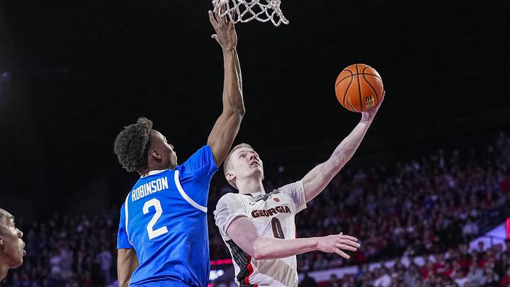 Jan 7, 2025; Athens, Georgia, USA; Georgia Bulldogs guard Blue Cain (0) shoots against Kentucky Wildcats guard Jaxson Robinson (2) during the first half at Stegeman Coliseum. Mandatory Credit: Dale Zanine-Imagn Images