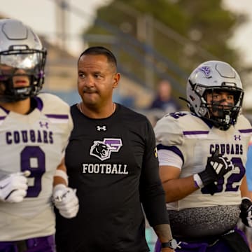 Franklin players and head football coach Ruben Torres take the field for the Cougars’ season opener against Chapin on Thursday, Aug. 28, 2025, at Irvin High School in El Paso, Texas.