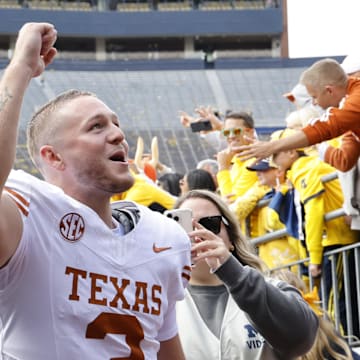 Sep 7, 2024; Ann Arbor, Michigan, USA; Texas Longhorns quarterback Quinn Ewers (3) celebrates after defeating the Michigan Wolverines at Michigan Stadium. Mandatory Credit: Rick Osentoski-Imagn Images