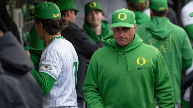 Oregon head coach Mark Wasikowski walks the dugout as the Oregon Ducks host the Minnesota Golden Gophers Saturday, March 15, 