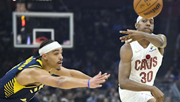 Apr 13, 2025; Cleveland, Ohio, USA; Cleveland Cavaliers forward Nae'Qwan Tomlin (30) throws a pass beside Indiana Pacers guard Andrew Nembhard (2) in the first quarter at Rocket Arena. Mandatory Credit: David Richard-Imagn Images