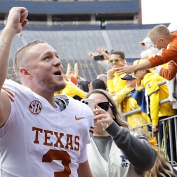 Sep 7, 2024; Ann Arbor, Michigan, USA; Texas Longhorns quarterback Quinn Ewers (3) celebrates after defeating the Michigan Wolverines at Michigan Stadium. Mandatory Credit: Rick Osentoski-Imagn Images