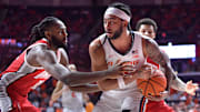 Feb 2, 2025; Champaign, Illinois, USA; Ohio State Buckeyes guard Evan Mahaffey (12) reaches for the ball as Illinois Fighting Illini guard Kylan Boswell (4) has possession during the second half at State Farm Center. Mandatory Credit: Ron Johnson-Imagn Images