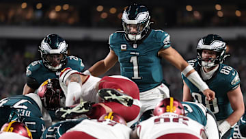 Jan 26, 2025; Philadelphia, PA, USA; Philadelphia Eagles quarterback Jalen Hurts (1) reacts as Washington Commanders linebacker Frankie Luvu (4) leaps over linemen before a snap during the second half in the NFC Championship game at Lincoln Financial Field. Mandatory Credit: Bill Streicher-Imagn Images