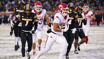 Nov 30, 2024; Columbia, Missouri, USA; Arkansas Razorbacks running back Ja'Quinden Jackson (22) scores a touchdown as Missouri Tigers safety Marvin Burks Jr. (1) looks on during the second half at Faurot Field at Memorial Stadium. Mandatory Credit: Denny Medley-Imagn Images