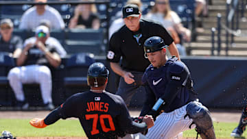 Feb 23, 2025; Tampa, Florida, USA; Detroit Tigers outfielder Jahmai Jones (70) is tagged out at home plate by New York Yankees catcher Alex Jackson (39) in the second inning during spring training at George M. Steinbrenner Field. Mandatory Credit: Nathan Ray Seebeck-Imagn Images
