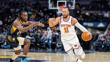 Feb 11, 2025; Indianapolis, Indiana, USA; New York Knicks guard Jalen Brunson (11) dribbles the ball while Indiana Pacers forward Aaron Nesmith (23) defends in the second half at Gainbridge Fieldhouse. Mandatory Credit: Trevor Ruszkowski-Imagn Images