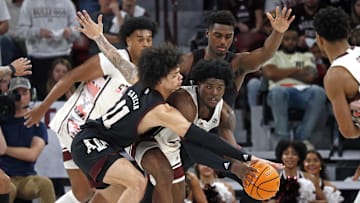 Feb 25, 2023; Starkville, Mississippi, USA; Mississippi State Bulldogs guard/forward Cameron Matthews (4) handles the ball as Texas A&M Aggies forward Andersson Garcia (11) and forward Henry Coleman III (15) defends during the second half at Humphrey Coliseum. Mandatory Credit: Petre Thomas-Imagn Images