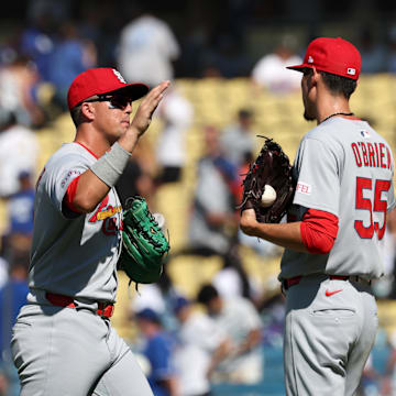 Aug 6, 2025; Los Angeles, California, USA;  St. Louis Cardinals left fielder Lars Nootbaar (21) and relief pitcher Riley O'Brien (55) celebrate a win after defeating the Los Angeles Dodgers 5-3 at Dodger Stadium. Mandatory Credit: Kiyoshi Mio-Imagn Images