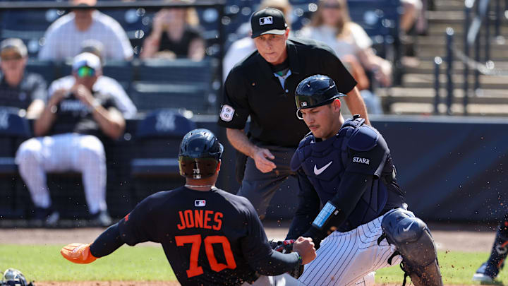 Feb 23, 2025; Tampa, Florida, USA; Detroit Tigers outfielder Jahmai Jones (70) is tagged out at home plate by New York Yankees catcher Alex Jackson (39) in the second inning during spring training at George M. Steinbrenner Field. Mandatory Credit: Nathan Ray Seebeck-Imagn Images