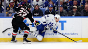 Dec 20, 2024; Buffalo, New York, USA;  Buffalo Sabres defenseman Mattias Samuelsson (23) checks Toronto Maple Leafs center Auston Matthews (34) as he goes for the puck during the first period at KeyBank Center. Mandatory Credit: Timothy T. Ludwig-Imagn Images