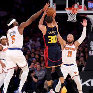 New York Knicks forward Precious Achiuwa (5) blocks a three point shot by Golden State Warriors guard Stephen Curry (30) in front of Knicks guard Jalen Brunson (11) during the third quarter at Madison Square Garden. Mandatory Credit: Brad Penner-Imagn Images