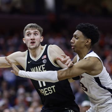 Feb 17, 2024; Charlottesville, Virginia, USA; Wake Forest Demon Deacons forward Andrew Carr (11) loses th ball as Virginia Cavaliers guard Ryan Dunn (13) defends in the first half at John Paul Jones Arena. Mandatory Credit: Geoff Burke-USA TODAY Sports
