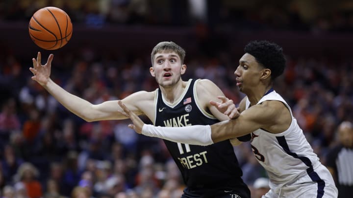 Feb 17, 2024; Charlottesville, Virginia, USA; Wake Forest Demon Deacons forward Andrew Carr (11) loses th ball as Virginia Cavaliers guard Ryan Dunn (13) defends in the first half at John Paul Jones Arena. Mandatory Credit: Geoff Burke-USA TODAY Sports