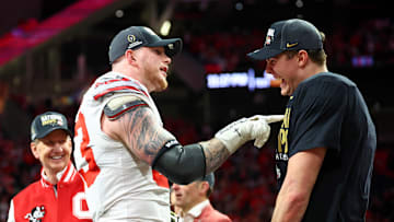 Jan 20, 2025; Atlanta, GA, USA; Ohio State Buckeyes defensive end Jack Sawyer (33) and quarterback Will Howard (18) celebrate after winning the CFP National Championship college football game at Mercedes-Benz Stadium. Mandatory Credit: Mark J. Rebilas-Imagn Images