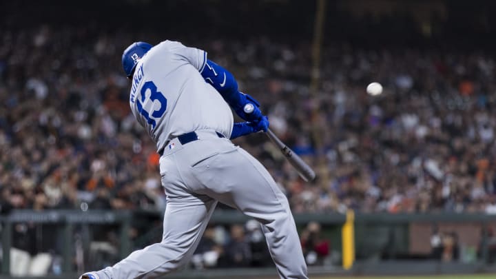 May 15, 2024; San Francisco, California, USA; Los Angeles Dodgers third baseman Max Muncy (13) hits a sacrifice fly for an RBI against the San Francisco Giants during the eighth inning at Oracle Park. Mandatory Credit: John Hefti-USA TODAY Sports