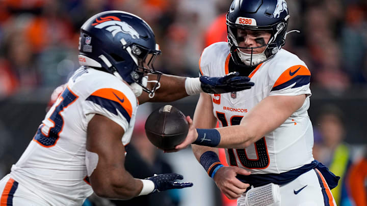 Denver Broncos quarterback Bo Nix (10) hands off to running back Audric Estime (23) in the second quarter of the NFL Week 17 game between the Cincinnati Bengals and the Denver Broncos at Paycor Stadium in downtown Cincinnati on Saturday, Dec. 28, 2024.