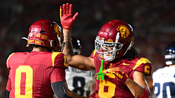 Sep 7, 2024; Los Angeles, California, USA; USC Trojans running back Quinten Joyner (0) celebrates with USC Trojans wide receiver Makai Lemon (6) after scoring a touchdown against the Utah State Aggies during the third quarter at United Airlines Field at Los Angeles Memorial Coliseum. Mandatory Credit: Jonathan Hui-Imagn Images