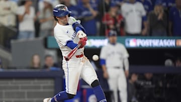 Oct 20, 2025; Toronto, Ontario, CAN; Toronto Blue Jays third baseman Ernie Clement (22) hits a single against the Seattle Mariners in the eighth inning during game seven of the ALCS round for the 2025 MLB playoffs at Rogers Centre. Mandatory Credit: John E. Sokolowski-Imagn Images