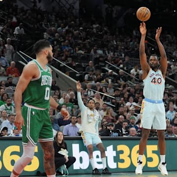 Mar 29, 2025; San Antonio, Texas, USA;  San Antonio Spurs forward Harrison Barnes (40) shoots in front of Boston Celtics forwards Jayson Tatum (0) and Sam Hauser (30) in the first half at Frost Bank Center. Mandatory Credit: Daniel Dunn-Imagn Images