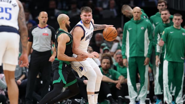 June 9, 2024;  Boston, Massachusetts, USA;  Dallas Mavericks guard Luka Doncic (77) controls the ball against Boston Celtics guard Derrick White (9) in the third quarter of Game 2 of the 2024 NBA Finals at TD Garden.  Mandatory Credit: Peter Casey – USA TODAY Sports