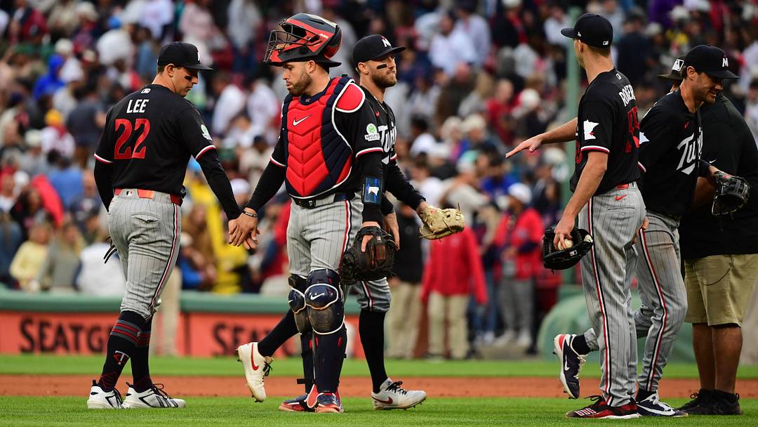 May 23, 2026; Boston, Massachusetts, USA; Minnesota Twins catcher Victor Caratini (37) celebrates with infielder Brooks Lee (22) and teammates after defeating the Boston Red Sox in the ninth inning at Fenway Park. 