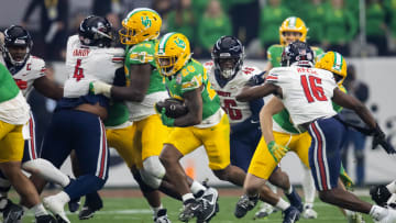 Jan 1, 2024; Glendale, AZ, USA; Oregon Ducks running back Jordan James (20) against the Liberty Flames during the 2024 Fiesta Bowl at State Farm Stadium. Mandatory Credit: Mark J. Rebilas-USA TODAY Sports