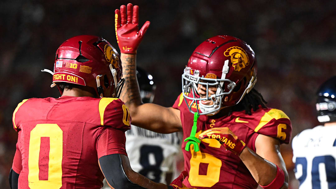 Sep 7, 2024; Los Angeles, California, USA; USC Trojans running back Quinten Joyner (0) celebrates with USC Trojans wide receiver Makai Lemon (6) after scoring a touchdown against the Utah State Aggies during the third quarter at United Airlines Field at Los Angeles Memorial Coliseum.