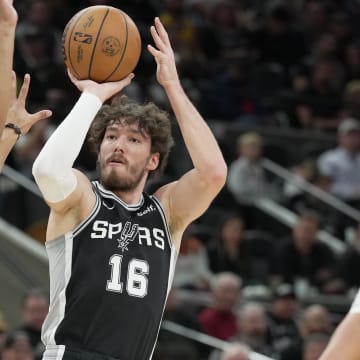 Dec 13, 2023; San Antonio, Texas, USA; San Antonio Spurs forward Cedi Osman (16) shoots over Los Angeles Lakers guard Max Christie (10) in the first half at Frost Bank Center. 
