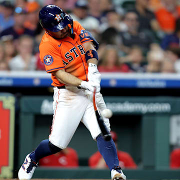 May 9, 2025; Houston, Texas, USA; Houston Astros designated hitter Jose Altuve (27) hits a double to left field against the Cincinnati Reds during the third inning at Daikin Park. 
